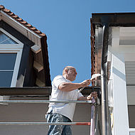 Maler beim Streichen einer Dachuntersicht